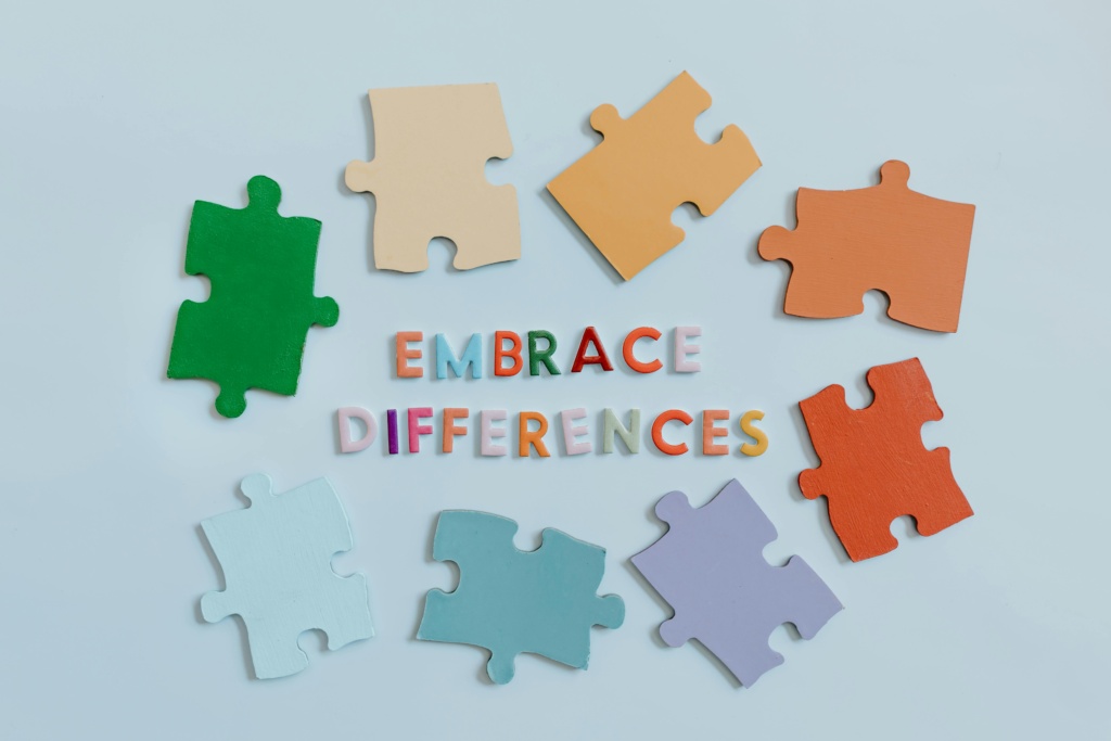 Colorful puzzle pieces surrounding 'embrace differences' text, symbolizing diversity and unity.